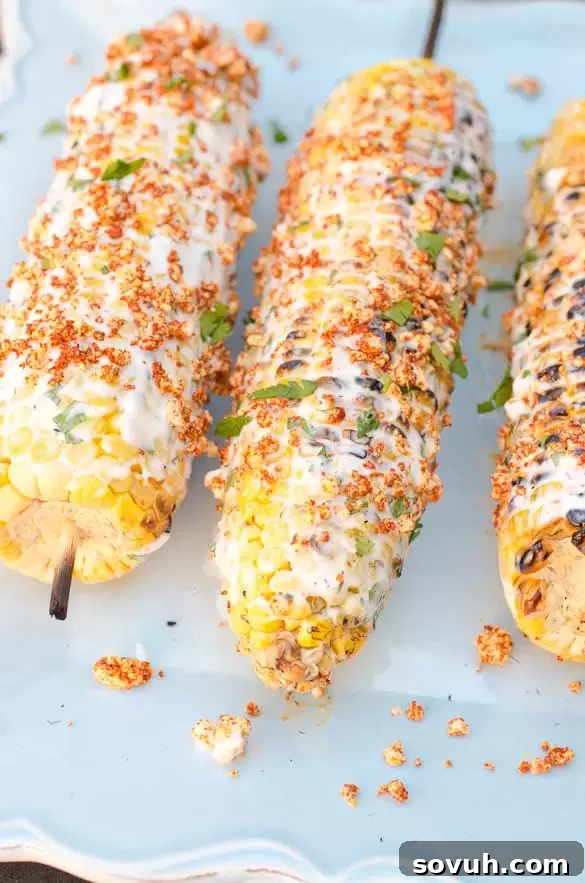 Creamy Mexican Street Corn (Elotes) topped with spiced cheese, a popular BBQ side.
