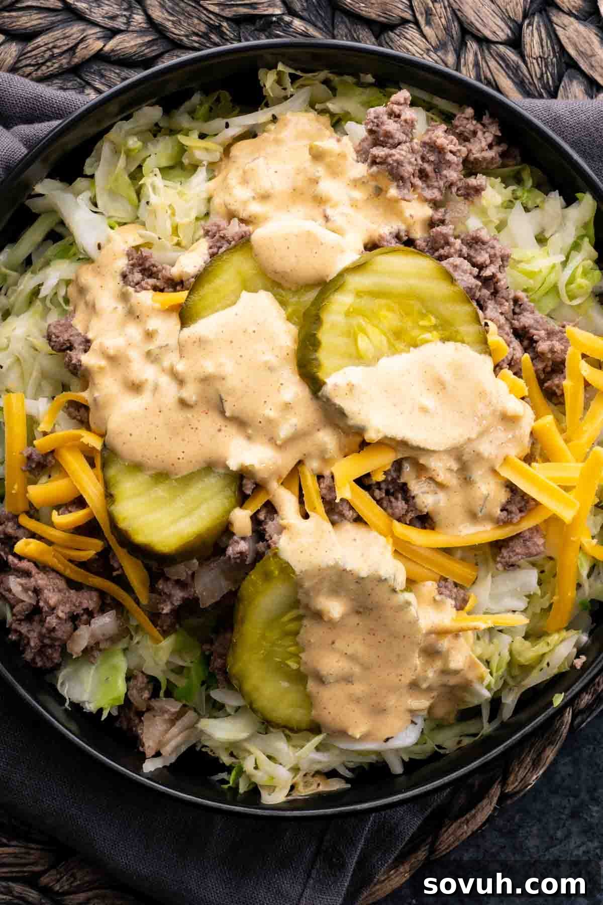 Keto Big Mac sauce drizzled generously over a Big Mac bowl