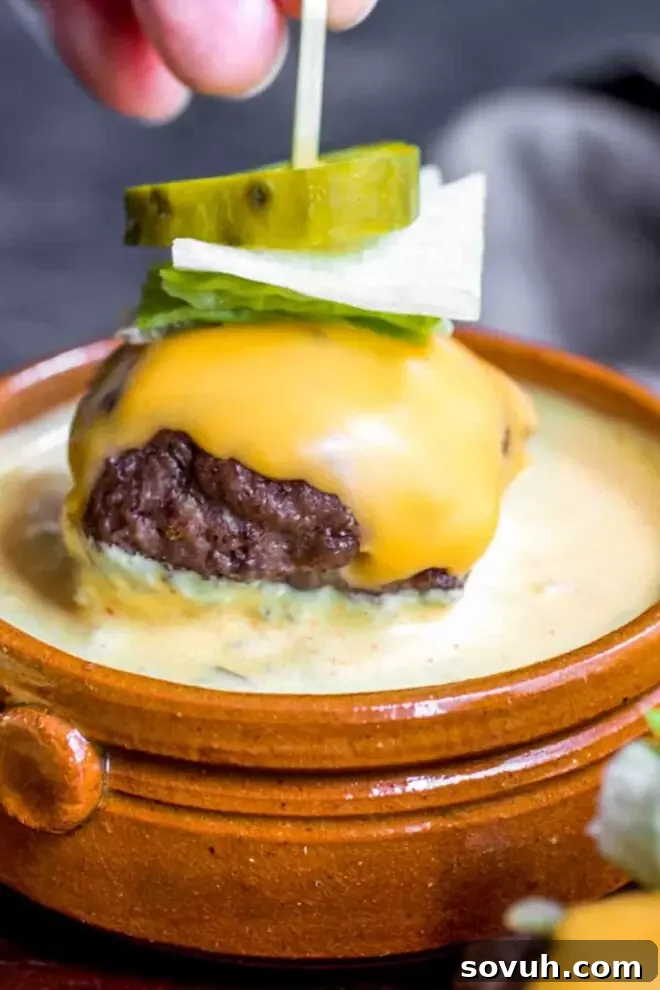 Mini cheeseburger dipped in a generous dollop of keto Big Mac sauce
