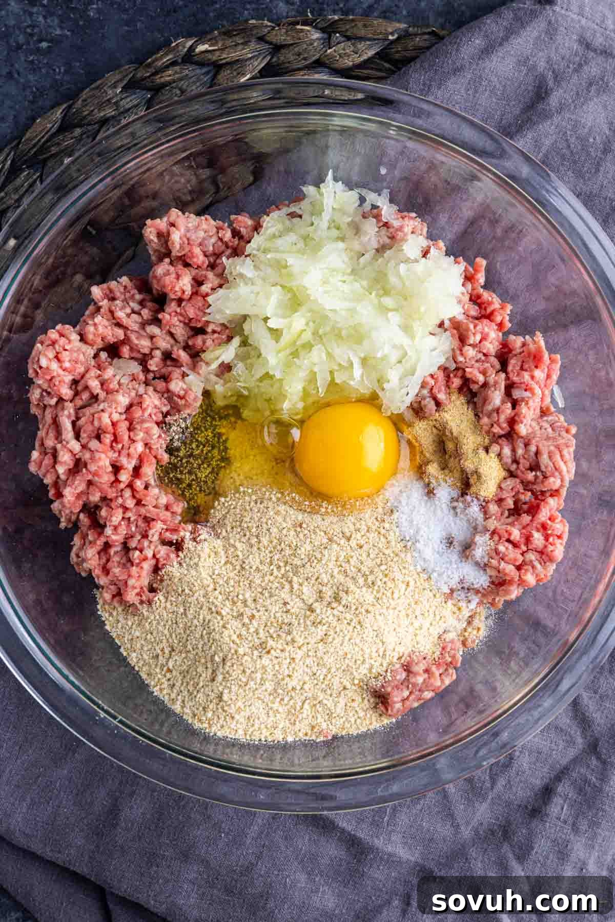 Hand-mixed meatloaf mixture in a large bowl, ready for shaping