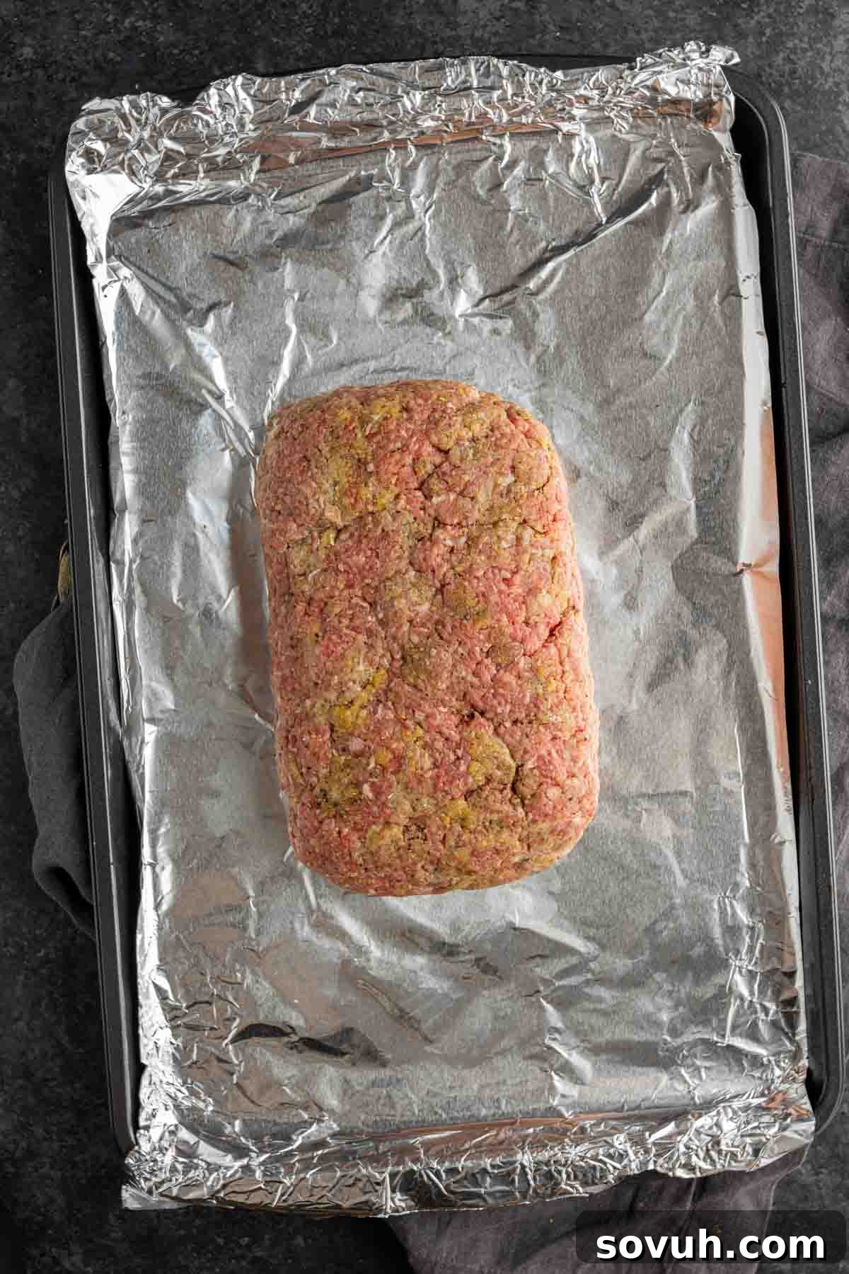 Uncooked meatloaf, perfectly shaped and ready for the oven