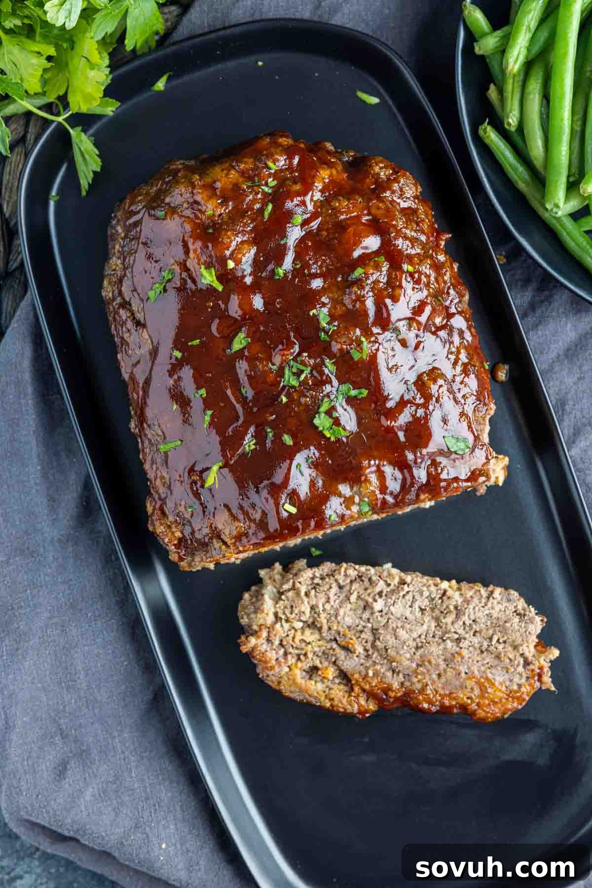 Hearty meatloaf served with mashed potatoes and green beans, perfect for a weeknight family dinner
