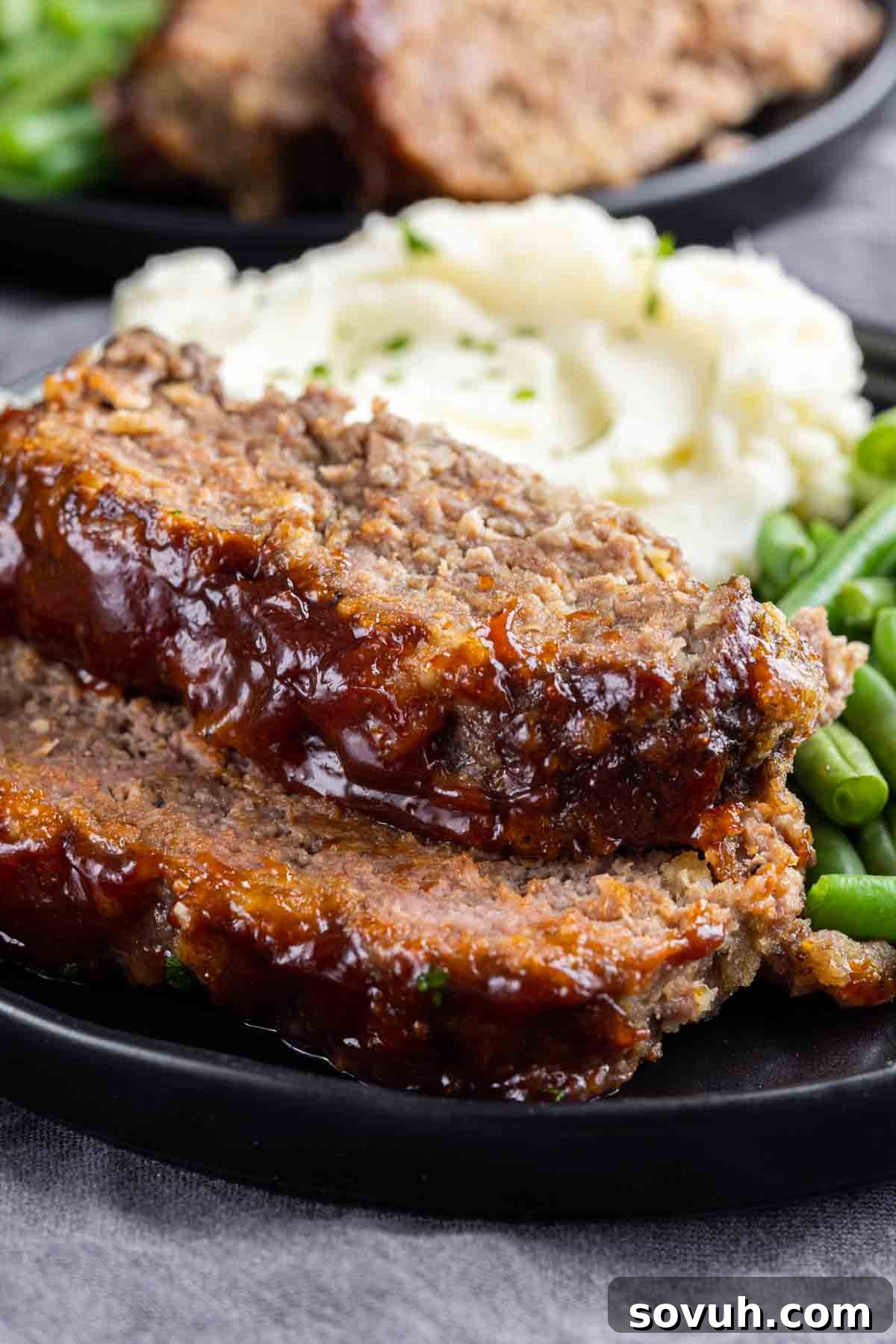 Slices of perfectly cooked meatloaf on a serving board