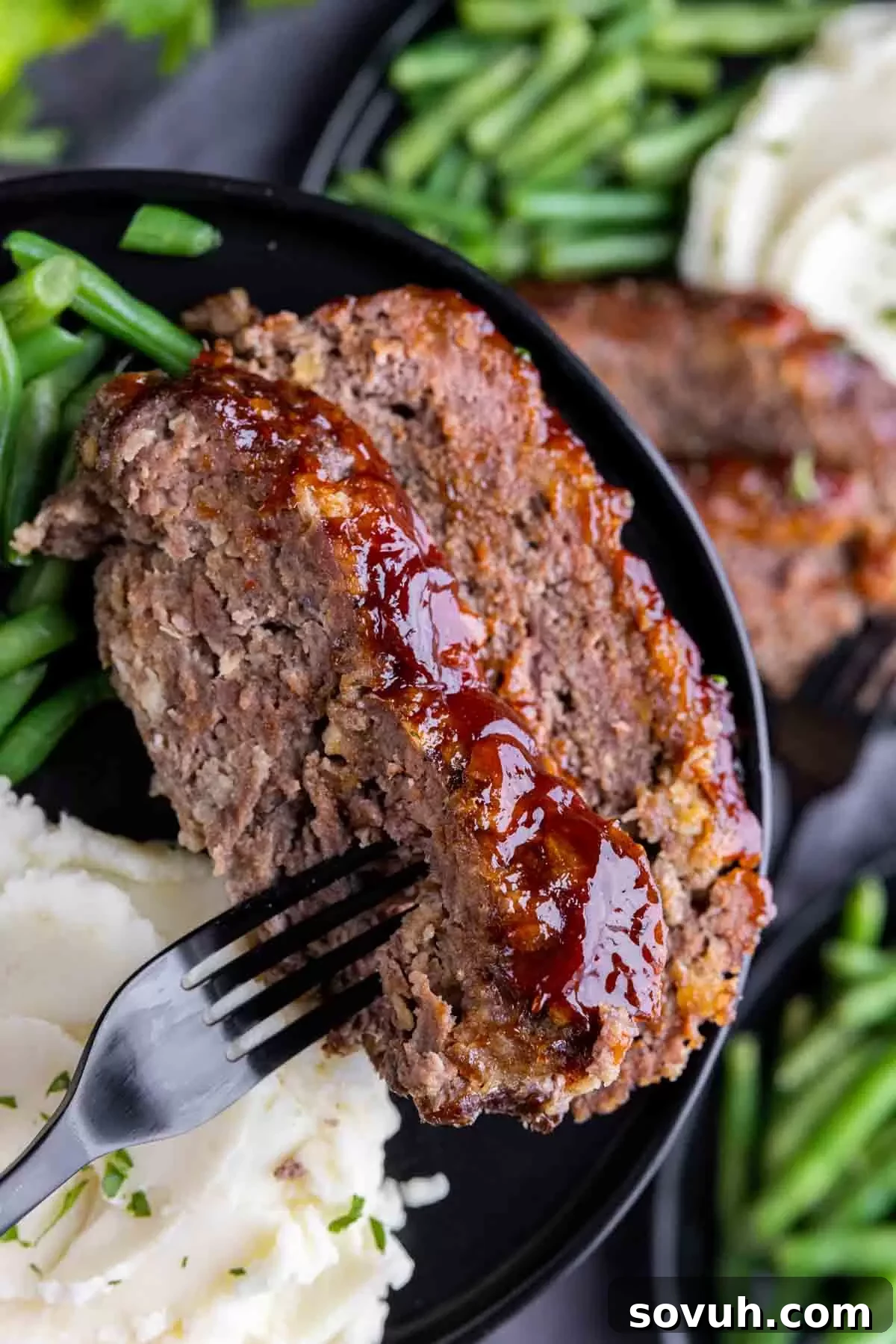 Hearty meatloaf for weekend meals, served alongside roasted vegetables
