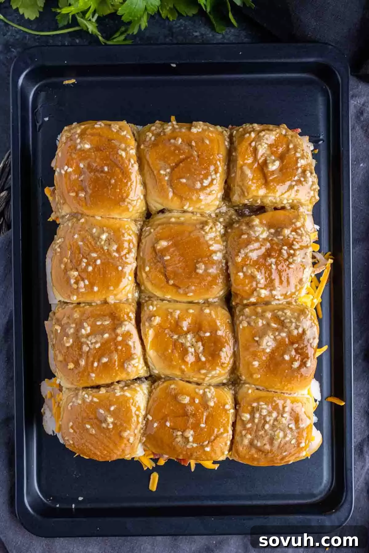 Turkey Sliders topped with a savory melted butter mixture before baking.