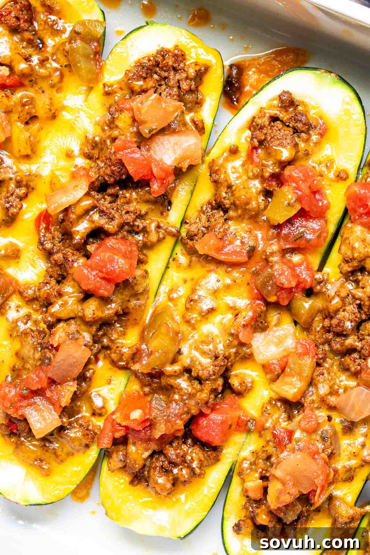 stuffed Taco Zucchini Boats with ground beef, cheese, and Rotel, garnished and ready to eat