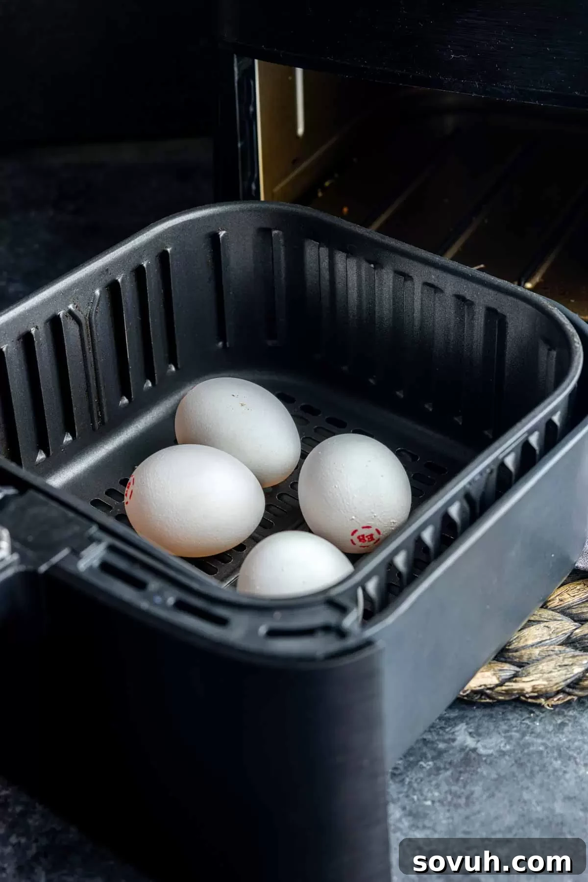 air fryer basket with air fryer eggs in it