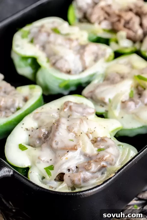 Close-up of cheesy Philly Cheesesteak Stuffed Peppers with melted provolone