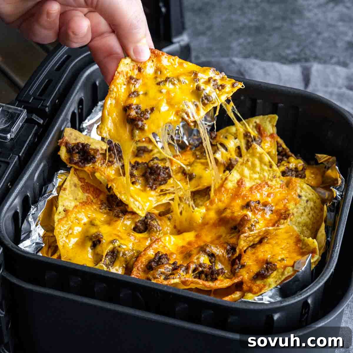 pulling Air Fryer Nachos out of the air fryer