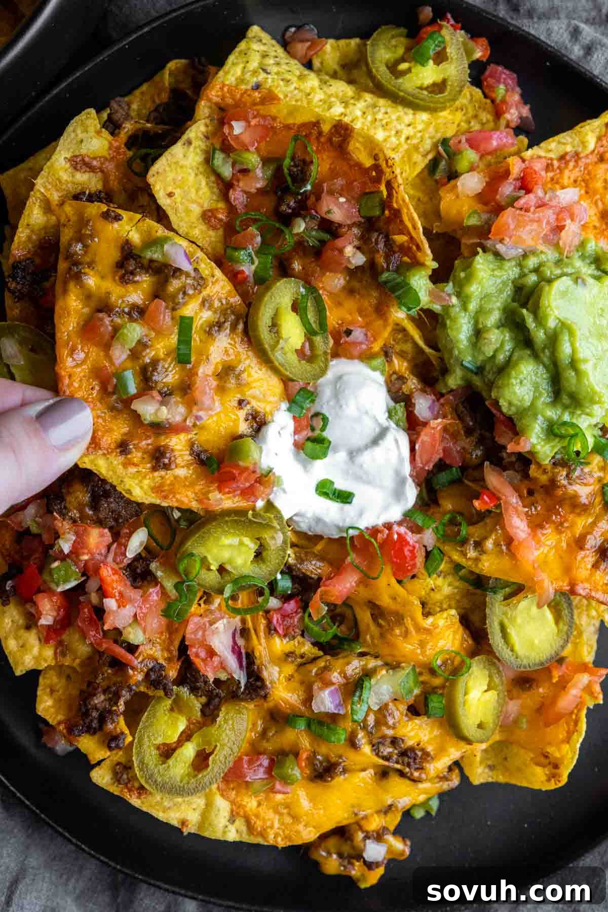 plate of Air Fryer Nachos with jalapenos, sour cream
