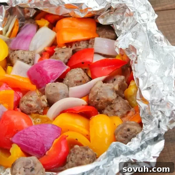 Grilled Italian Sausage and Pepper Foil Packet ready to be enjoyed, showing a close-up of the perfectly cooked ingredients.