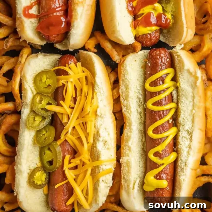 Air Fryer Hot Dogs on a platter with fries, showing their perfectly cooked and slightly crispy texture.