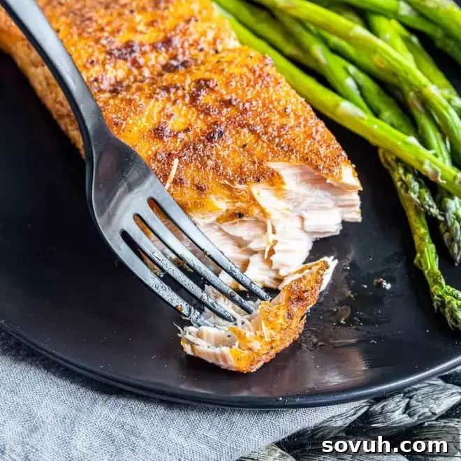 flaky Air Fryer Salmon, garnished with fresh dill and lemon slices.