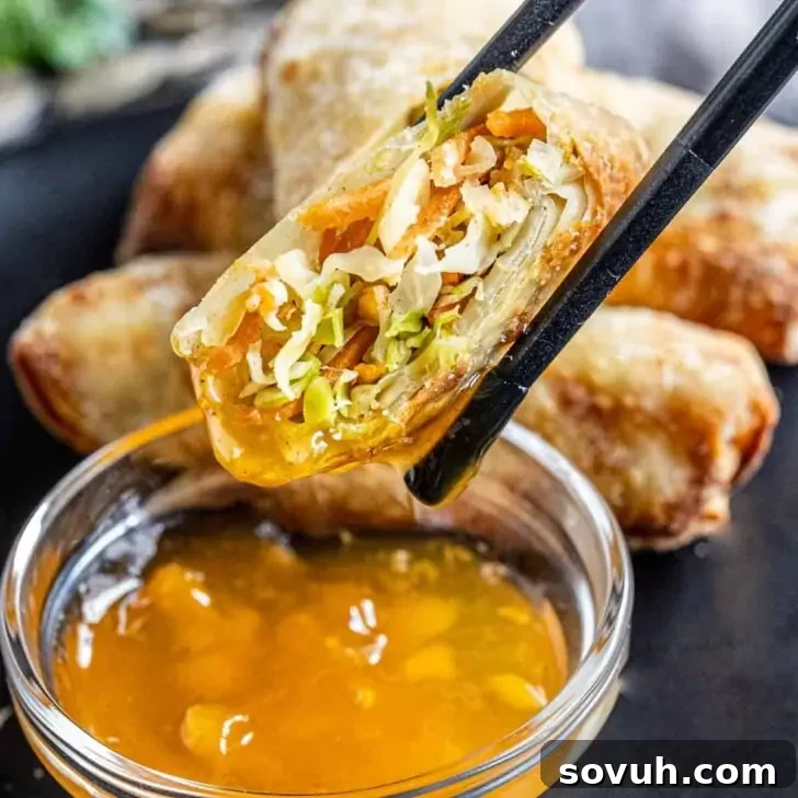 Air Fryer Egg Rolls and duck sauce, showing beautifully crispy wrappers.