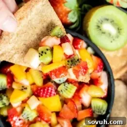 Scoop of fruit salsa on a baked cinnamon chip