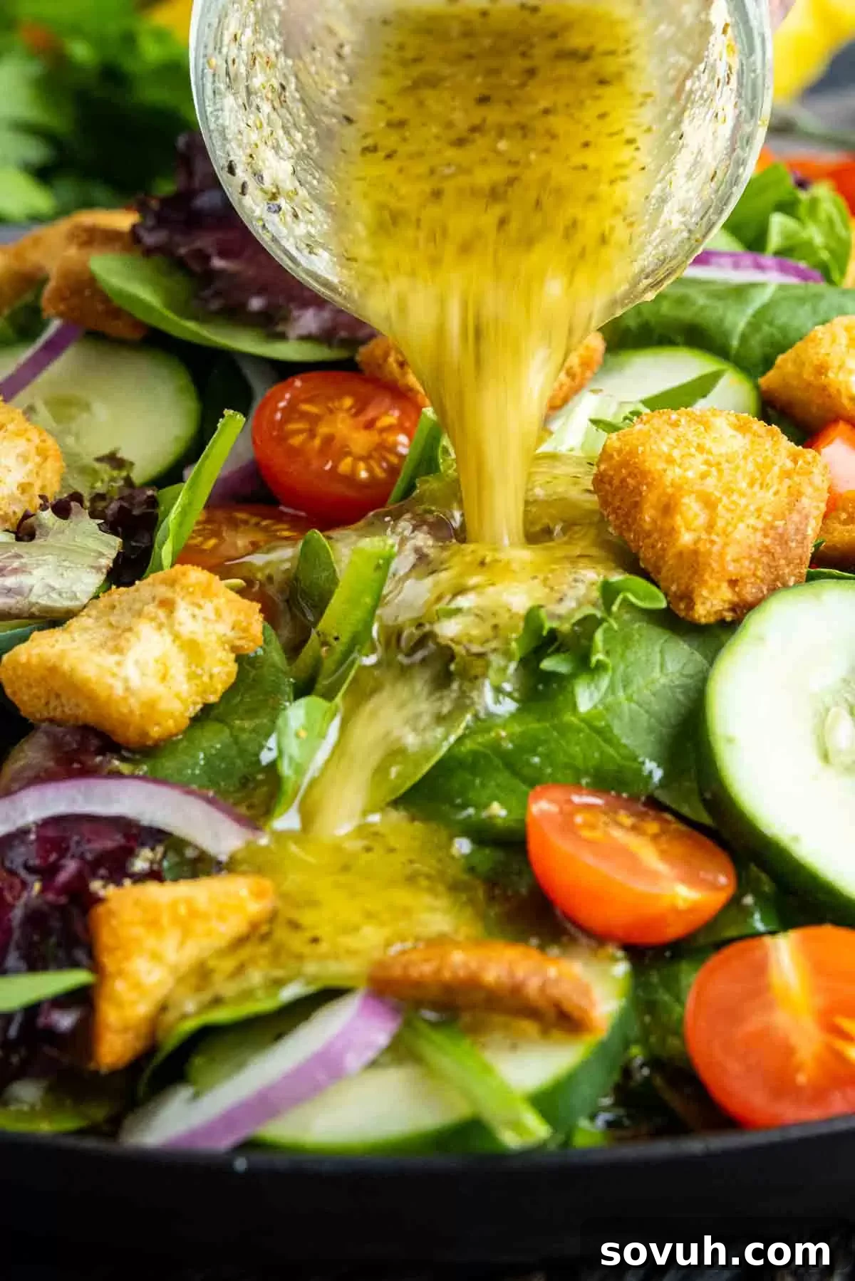 pouring Homemade Italian Dressing out of a mason jar