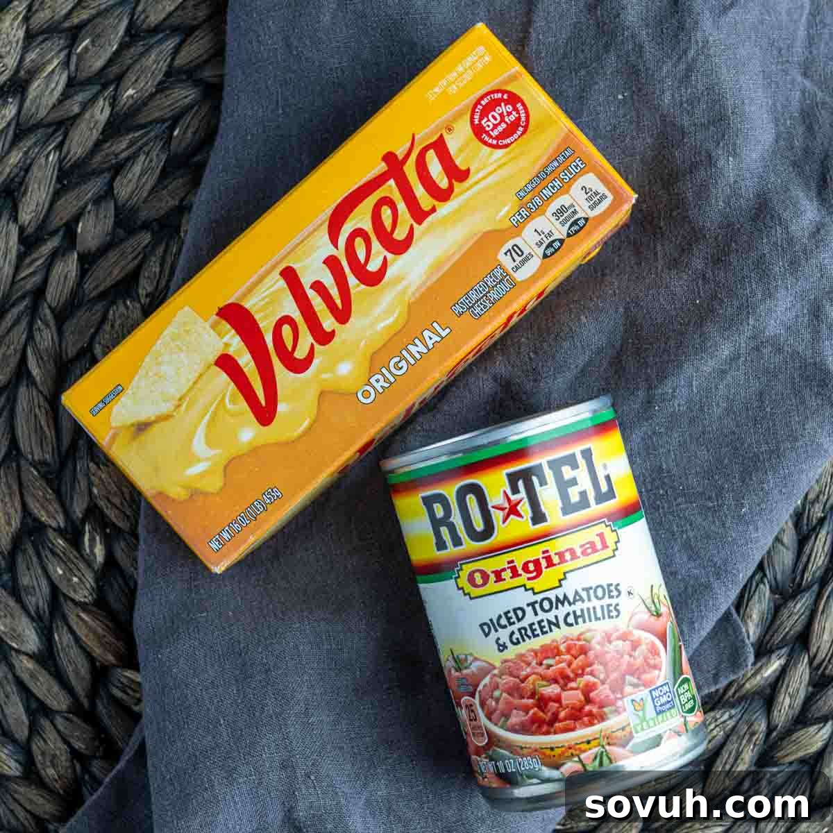 Ingredients for Rotel Dip laid out, including a block of Velveeta cheese and a can of Rotel diced tomatoes and green chilies.