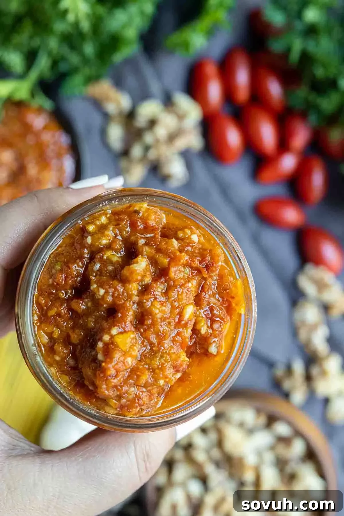 holding a jar of Pesto Rosso