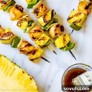 Delicious Grilled Pineapple Teriyaki Chicken Skewers with vibrant peppers and onions, a perfect summer dinner.