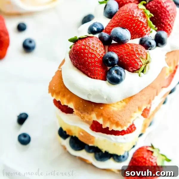 A beautiful No Bake Red White and Blue Cake, brimming with whipped cream and fresh summer berries.