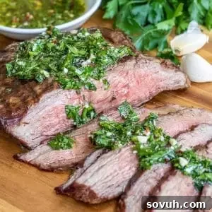 A succulent and tender Chimichurri Steak, showcasing a beautiful char from the grill.