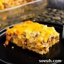 A slice of John Wayne Casserole on a black plate.