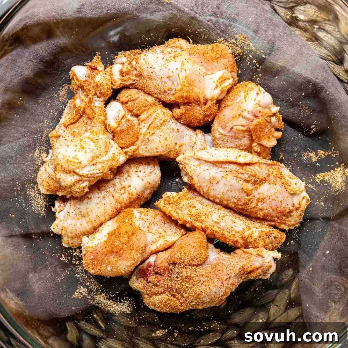 Seasoned chicken wings in a bowl ready to be cooked for Honey Garlic Chicken Wings