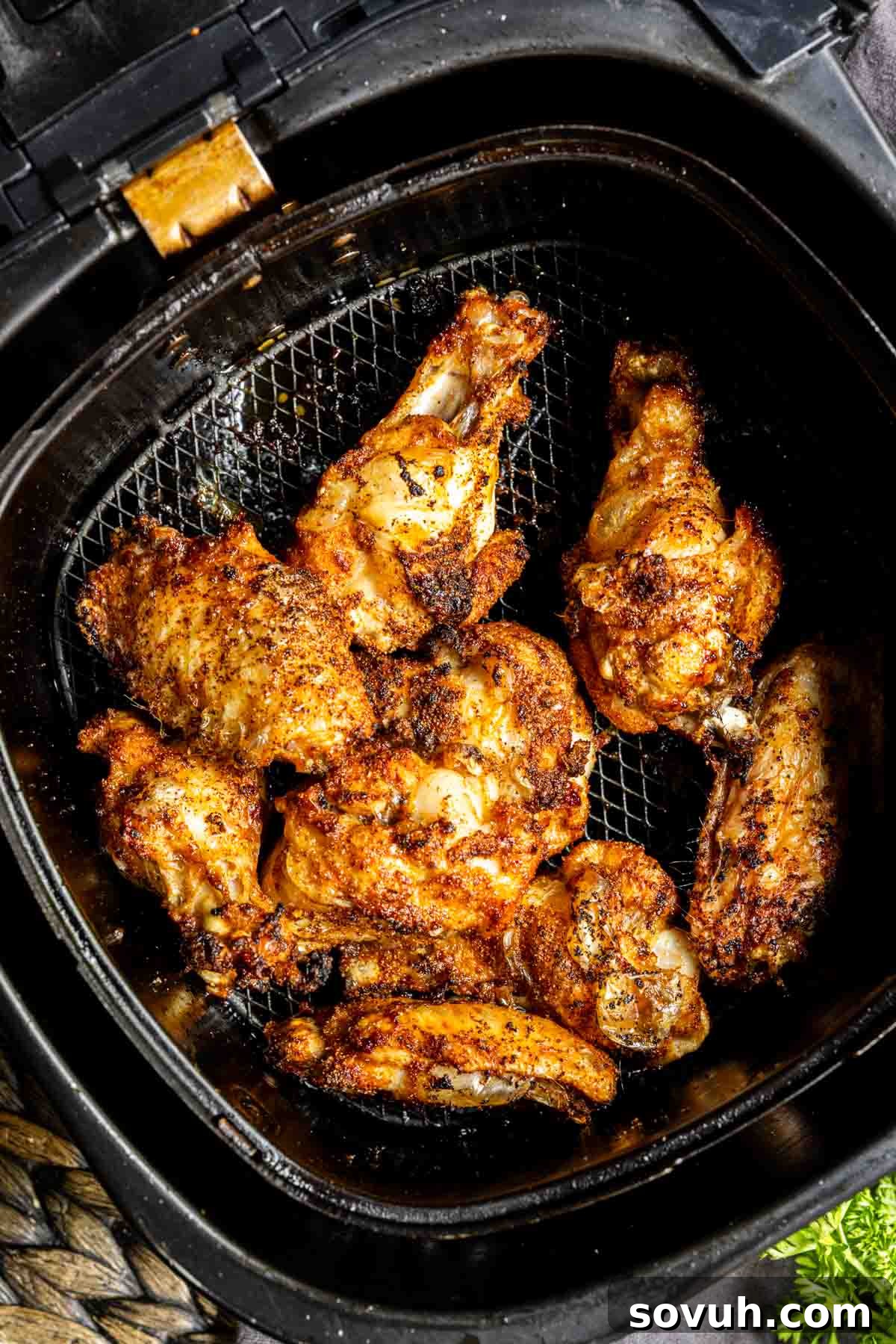 Air fryer with Honey Garlic Chicken Wings inside, cooking to crispy perfection.
