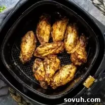 Frozen Chicken Wings in the Air Fryer in an air fryer basket.