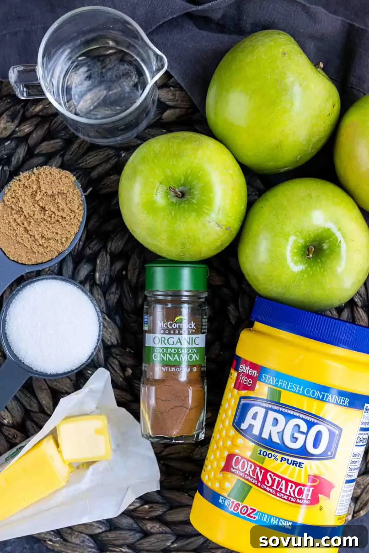 The fresh ingredients for homemade apple pie filling laid out on a wicker mat.