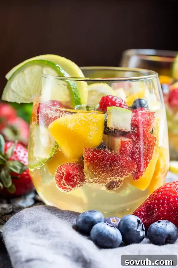 Side shot of Summer Moscato Sangria in stemless wine glasses filled with summer fruit