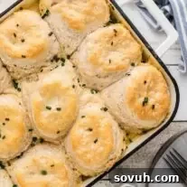 A casserole dish filled with biscuits and gravy casserole