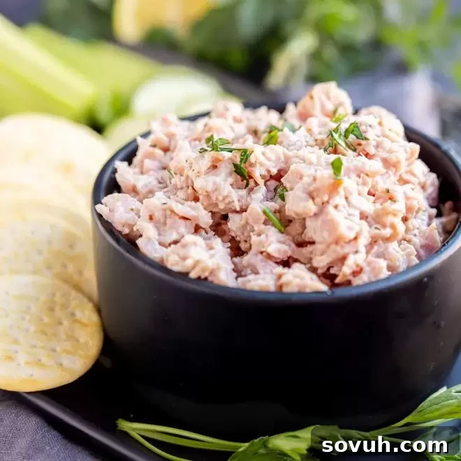 A stylish black bowl generously filled with savory deviled ham spread, ready for serving with crackers or bread.
