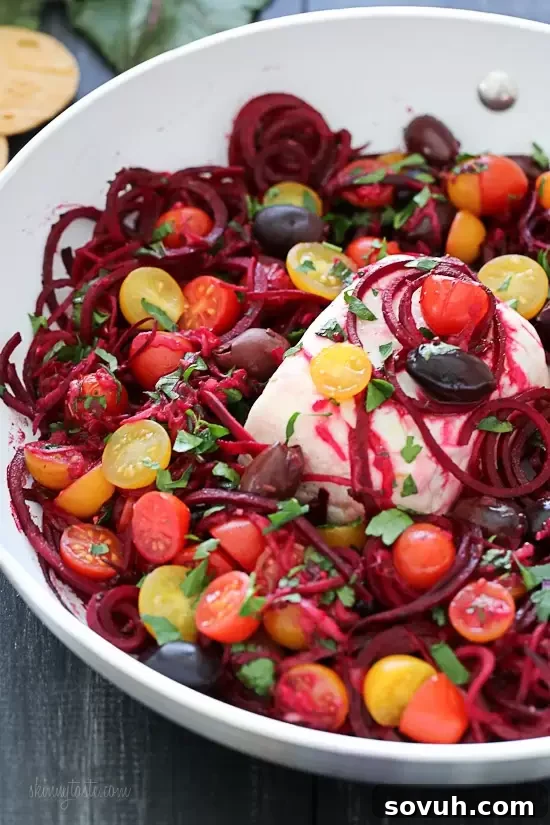 A vibrant raw spicy zoodle bowl, brimming with colorful spiralized vegetables and a zesty dressing, embodying a healthy and delicious vegan meal.