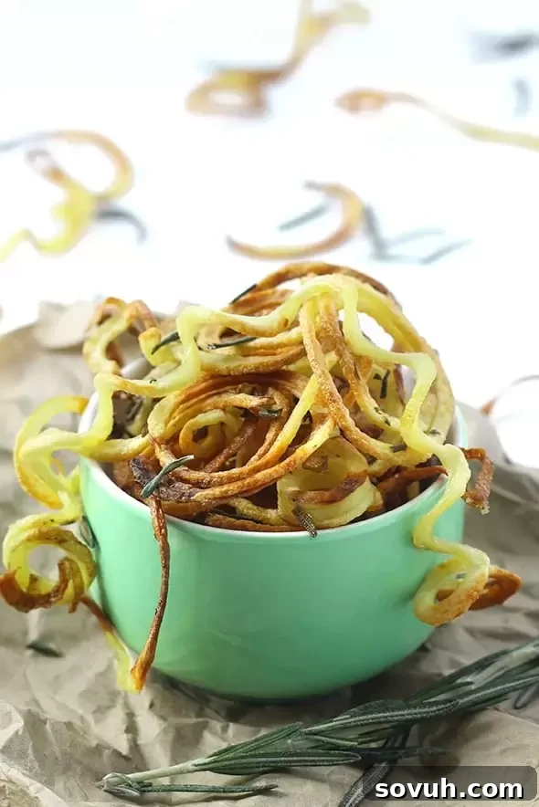 A colorful and vibrant raw beet and sweet potato salad, beautifully arranged with spiralized vegetables, highlighting freshness and nutrition.
