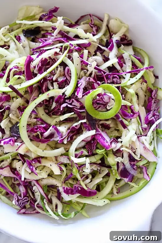 A delectable bowl of zucchini noodle Pad Thai, garnished with peanuts, fresh cilantro, and a lime wedge, offering a healthy and flavorful low-carb meal.