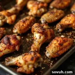 Crispy Old Bay Wings on a baking sheet, ready to be served.