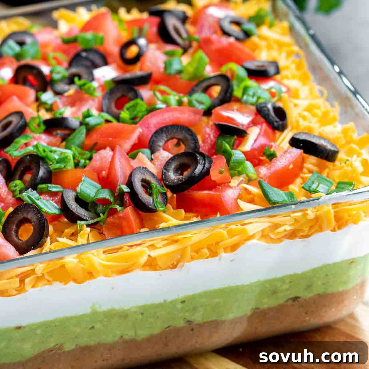 Mastering the Potluck: Unforgettable Dishes for Any Gathering 13 make ahead 7 Layer Dip in glass dish