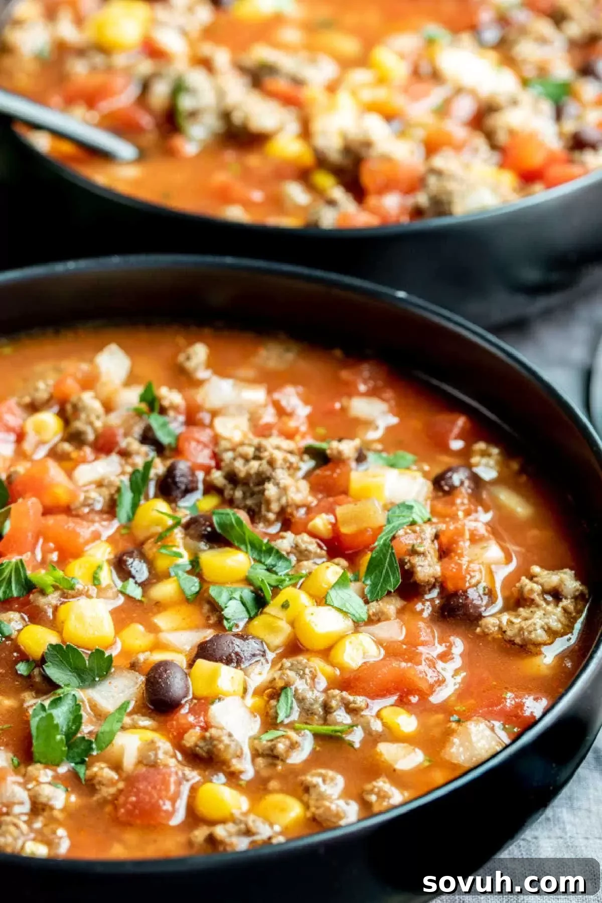 A bowl of Slow Cooker Taco Soup with various toppings like sour cream and cheese.
