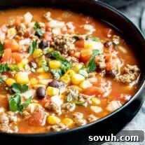A black bowl filled with taco soup slow cooker
