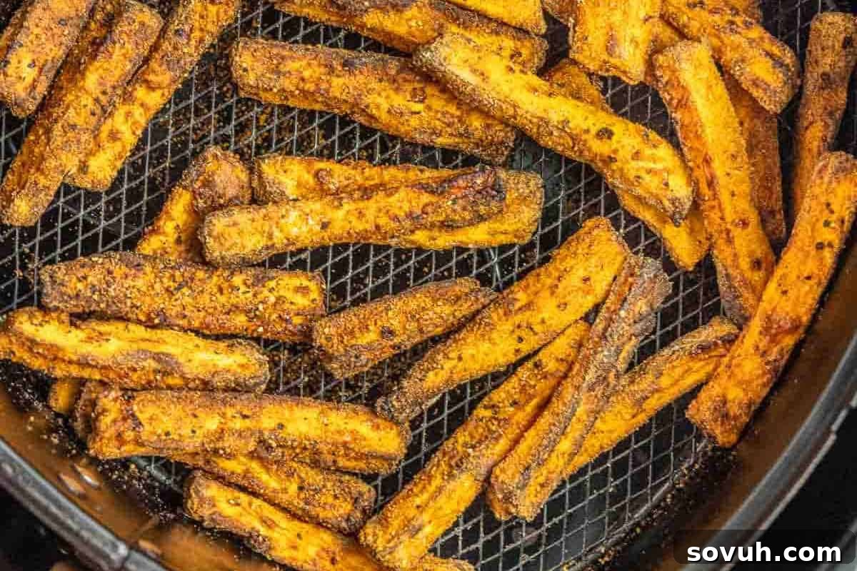 crispy homemade sweet potato fries in an air fryer basket