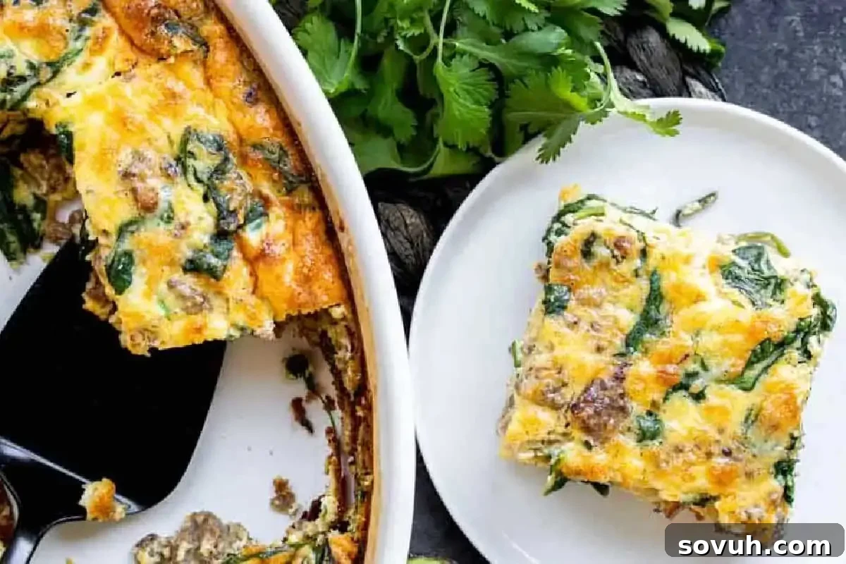 A slice of spinach and mushroom frittata on a white plate beside a full dish, garnished with fresh cilantro.