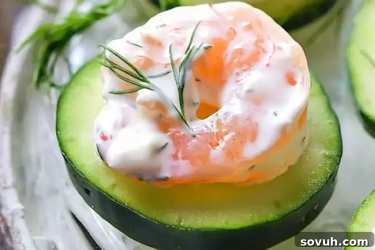 Shrimp salad with creamy dressing served on a halved avocado garnished with dill.