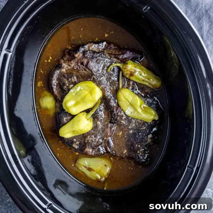 Mississippi Pot Roast: Slow Cooked Southern Charm 4 Shredded Slow Cooker Mississippi Pot Roast and pepperoncini peppers in its rich brown gravy.