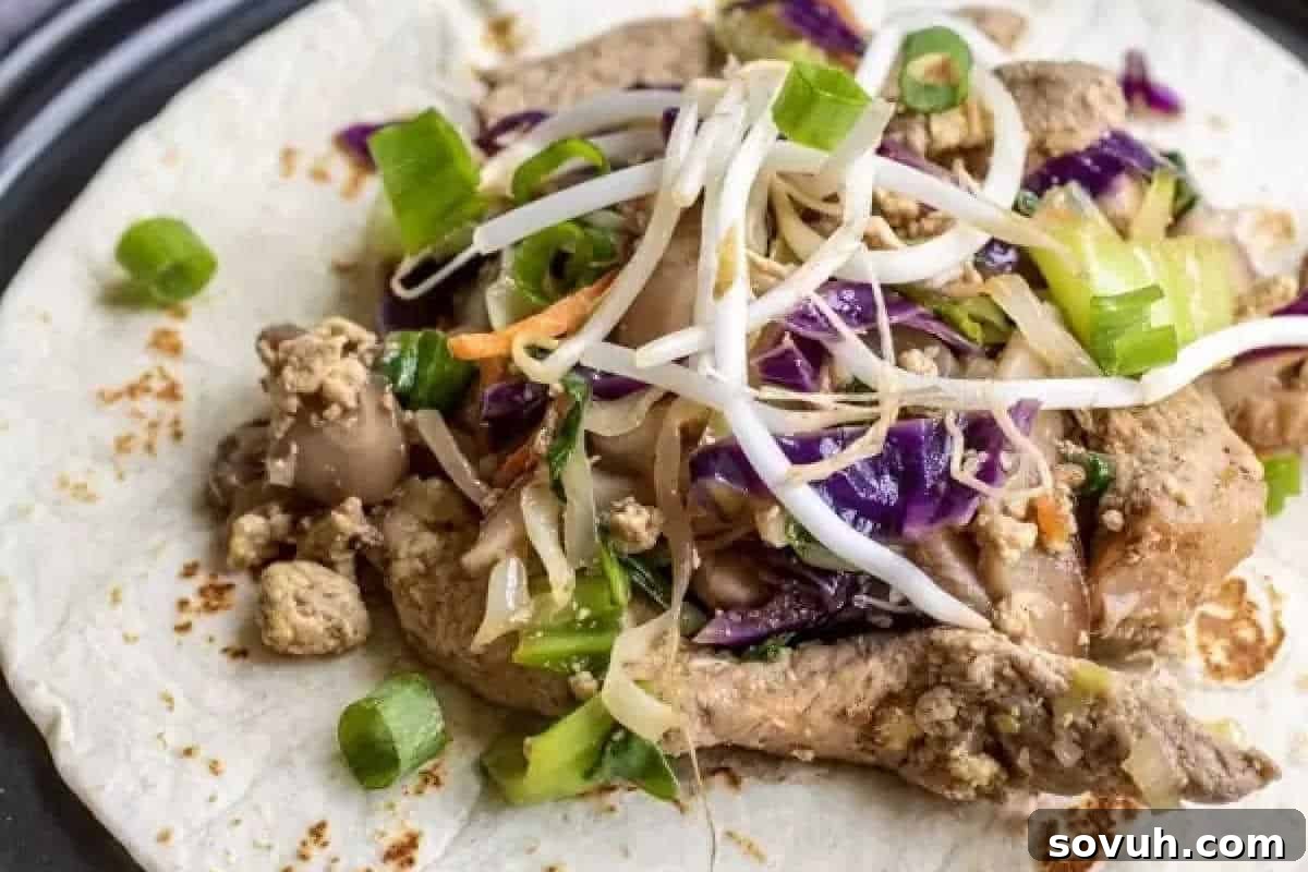 A tortilla topped with stir-fried vegetables, including bean sprouts, shredded cabbage, mushrooms, and green onions.