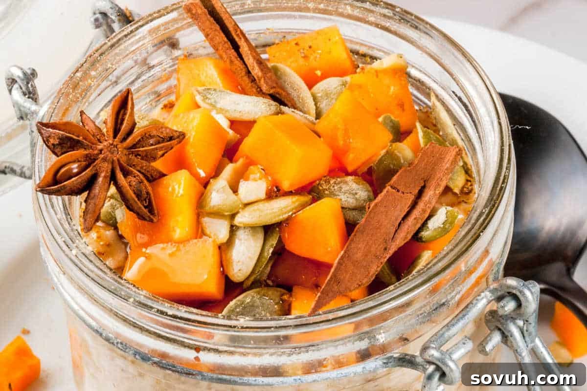 An inviting jar of overnight oats, beautifully garnished with finely chopped pumpkin pieces, crunchy pumpkin seeds, a delicate star anise, and fragrant cinnamon sticks, all presented on a pristine white plate, promising a wholesome and flavorful autumn breakfast.