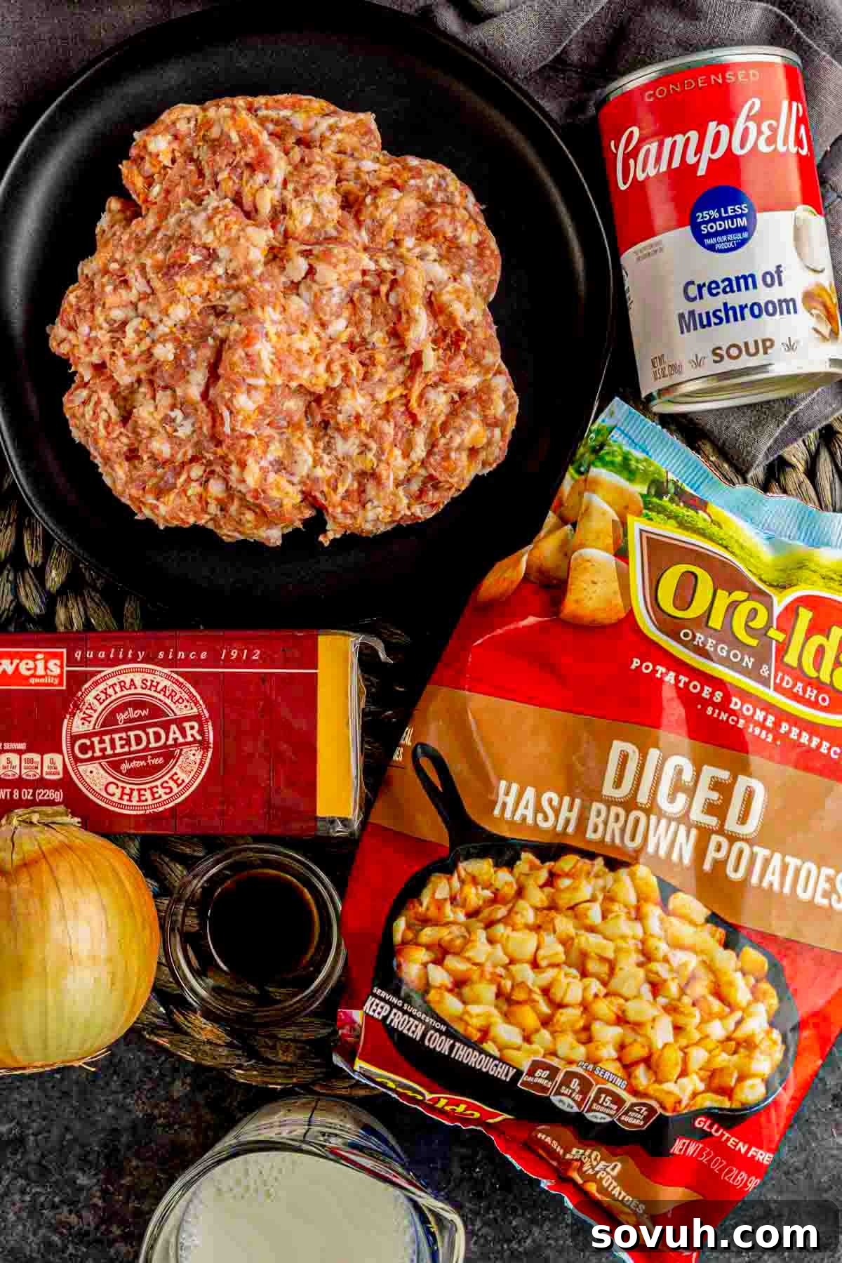 A vibrant display of fresh ingredients for a quick and easy cheesy Sausage Potato Casserole, including sausage, diced potatoes, cheese, and soup.