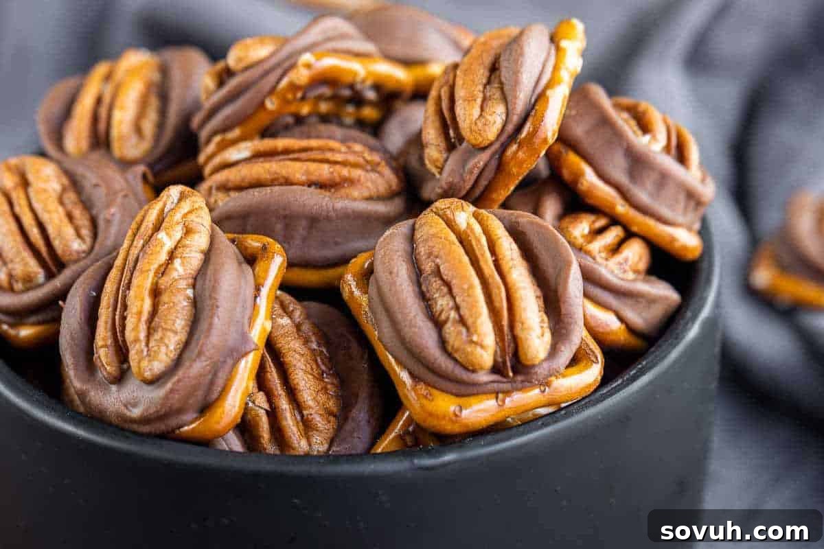 A stylish black bowl elegantly showcases a collection of sweet and salty Rolo Pretzel Turtle Candies, each featuring a buttery Rolo caramel melted atop a crispy pretzel, crowned with a crunchy pecan nut.