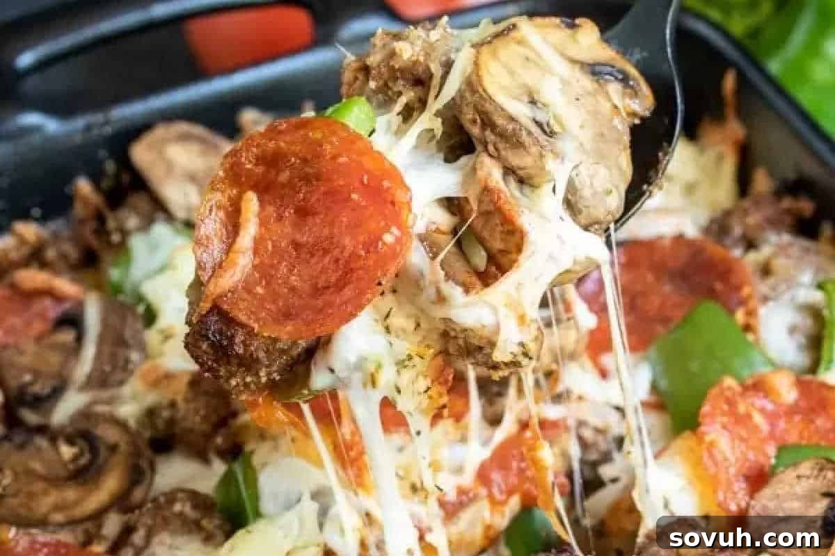 A close-up view of a scrumptious slice of pizza being lifted from a pan, with gooey melted cheese stretching enticingly. The thick crust is generously topped with pepperoni, mushrooms, green peppers, and savory sausage.