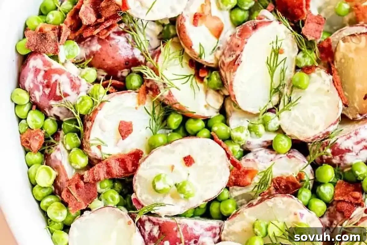 Fresh English Pea and Potato Salad with crispy bacon bits and fragrant dill in a serving bowl, ready for spring gatherings.